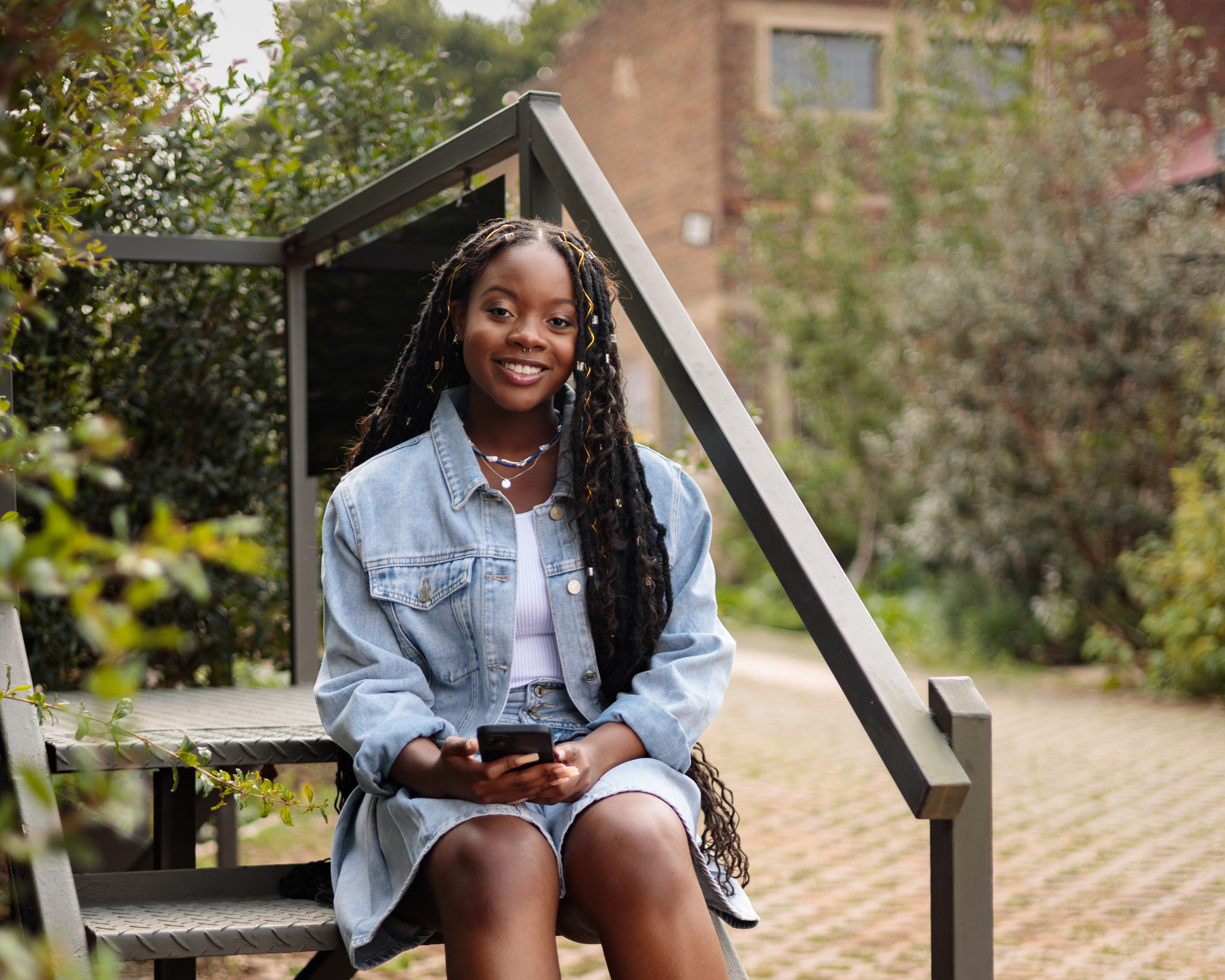 Girl sitting on the steps smiling.